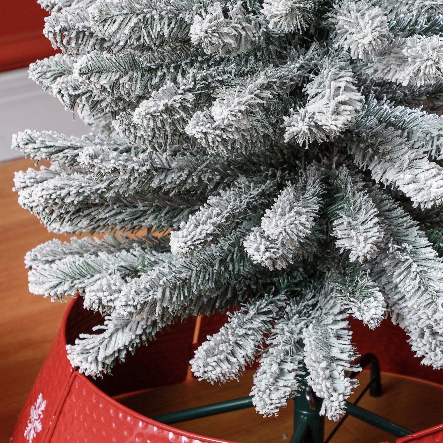 Close up of flocked artificial Christmas tree branches with frosted tips