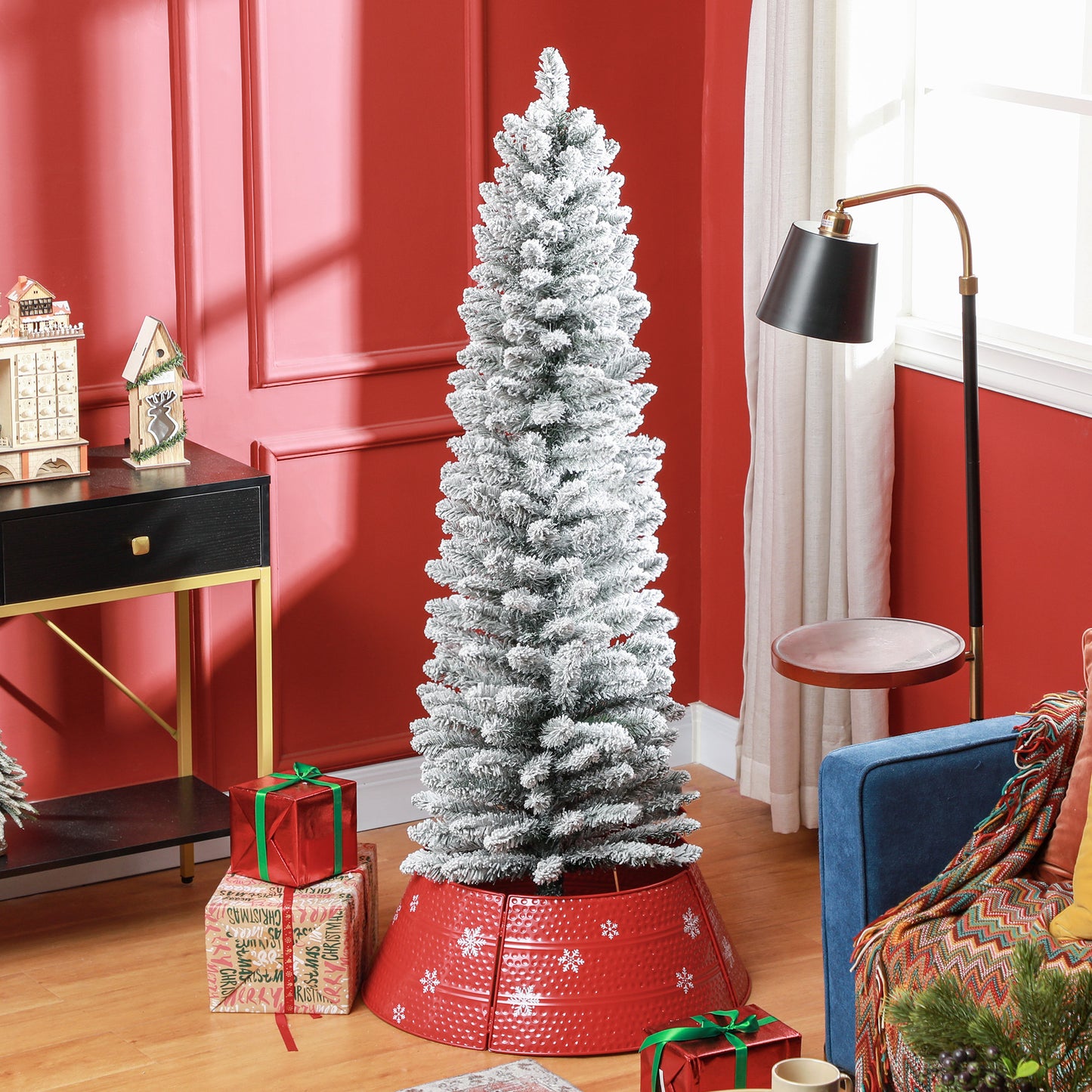 Flocked pine Christmas tree with snowdusted branches and a red snowflake tree skirt