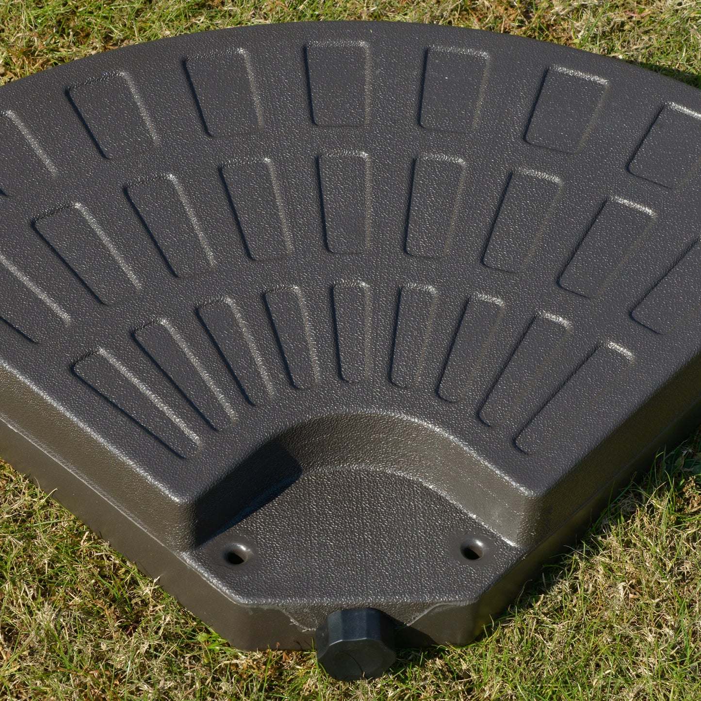 Dark gray patio umbrella base with textured surface and builtin handle