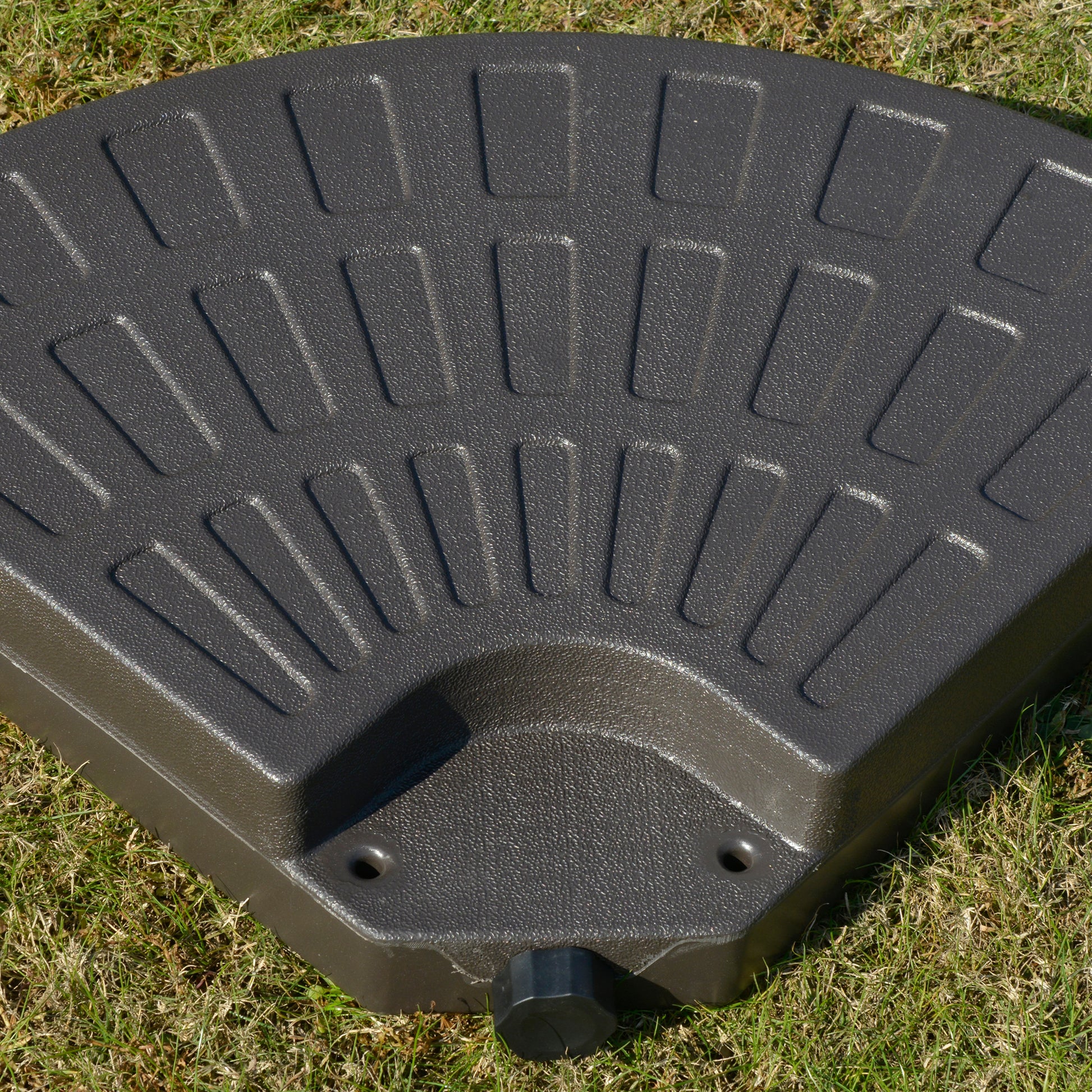 Dark gray patio umbrella base with textured surface and builtin handle