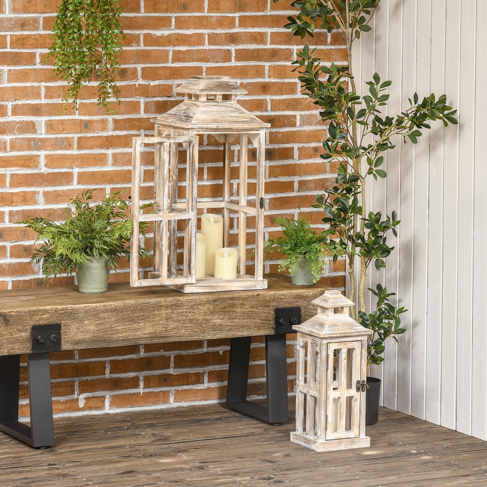 Rustic white wooden lantern with three faux candles inside on a rustic bench