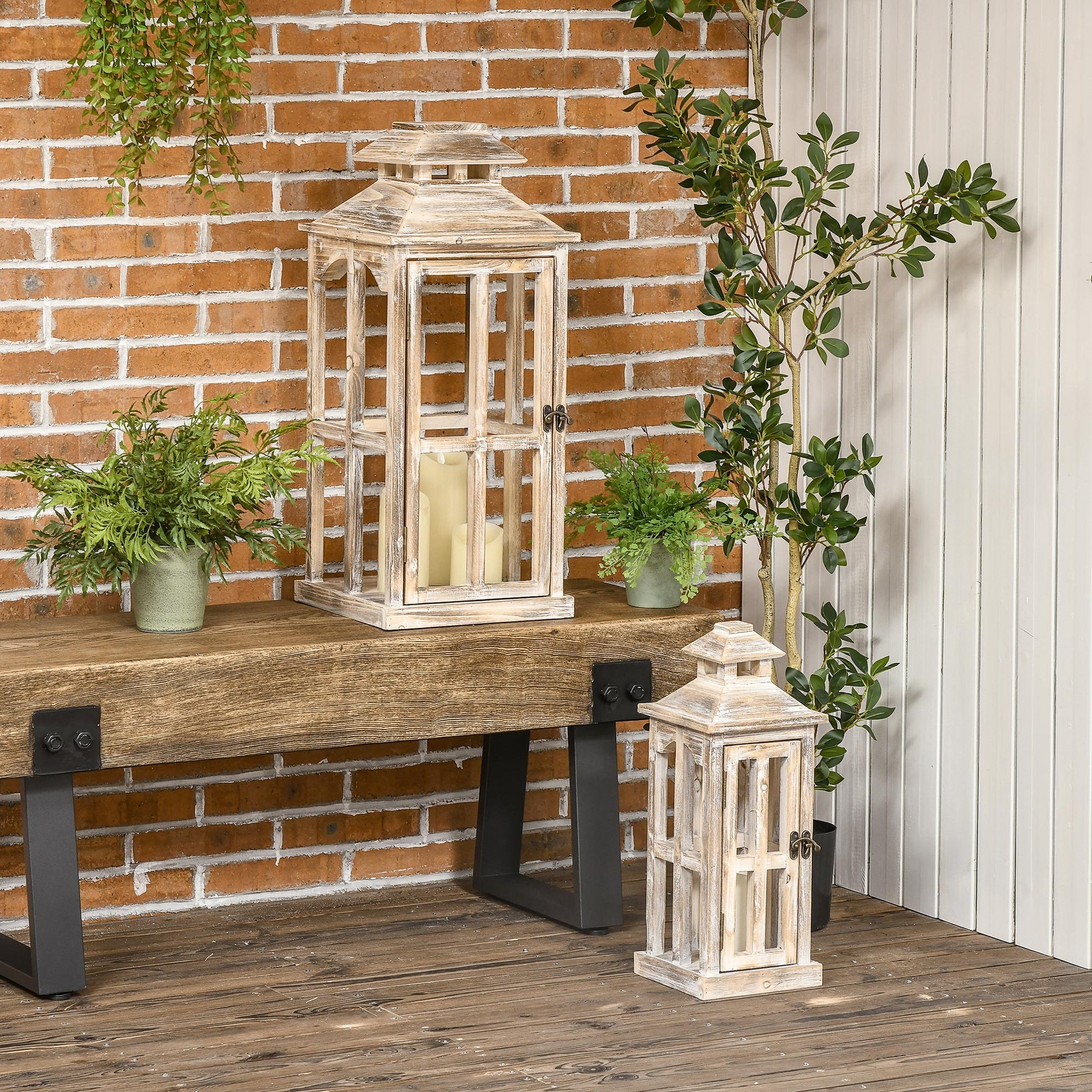 Tall distressed white wooden lantern with glass panels and pillar candle inside
