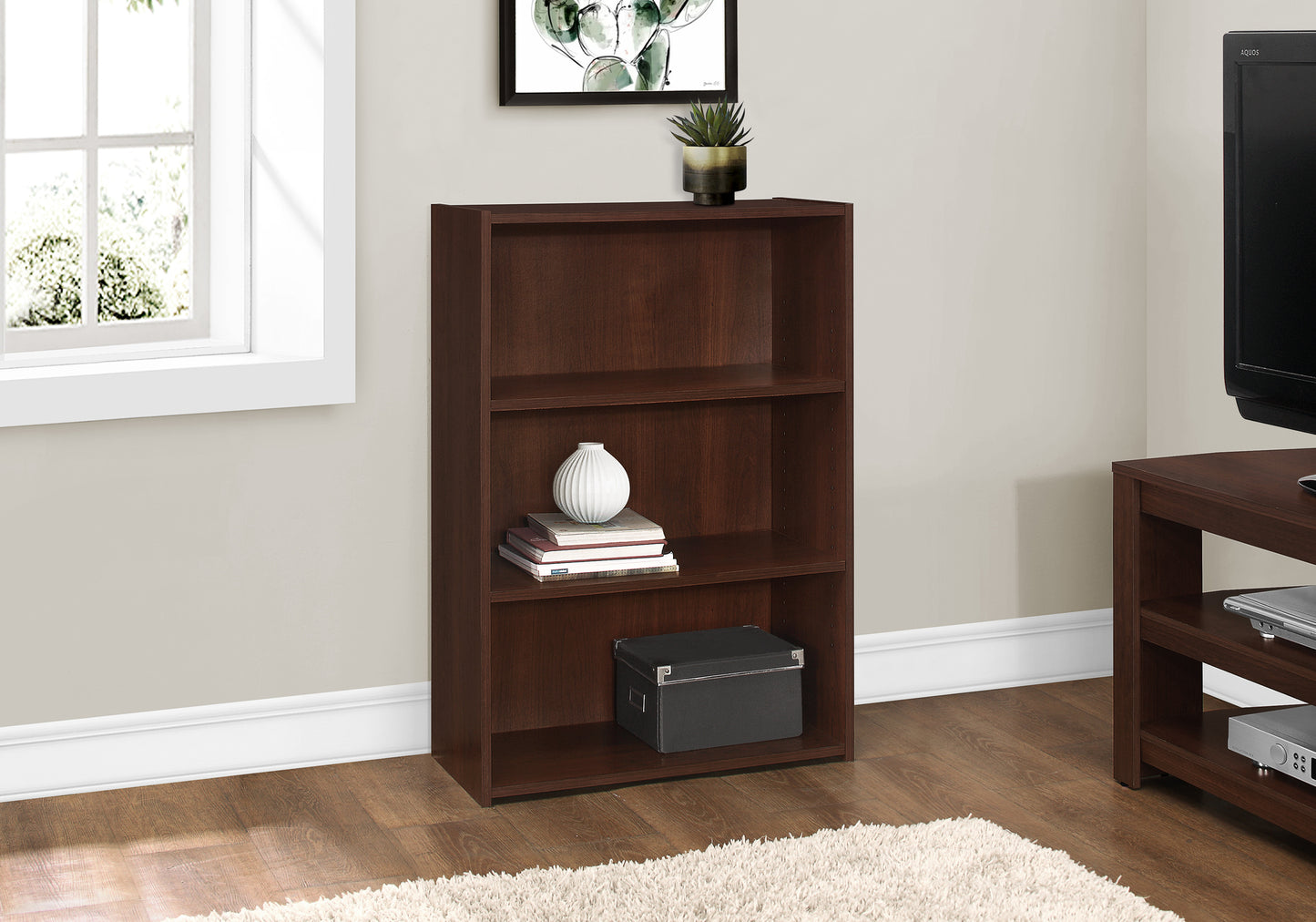 Dark brown threeshelf bookshelf with decorative items