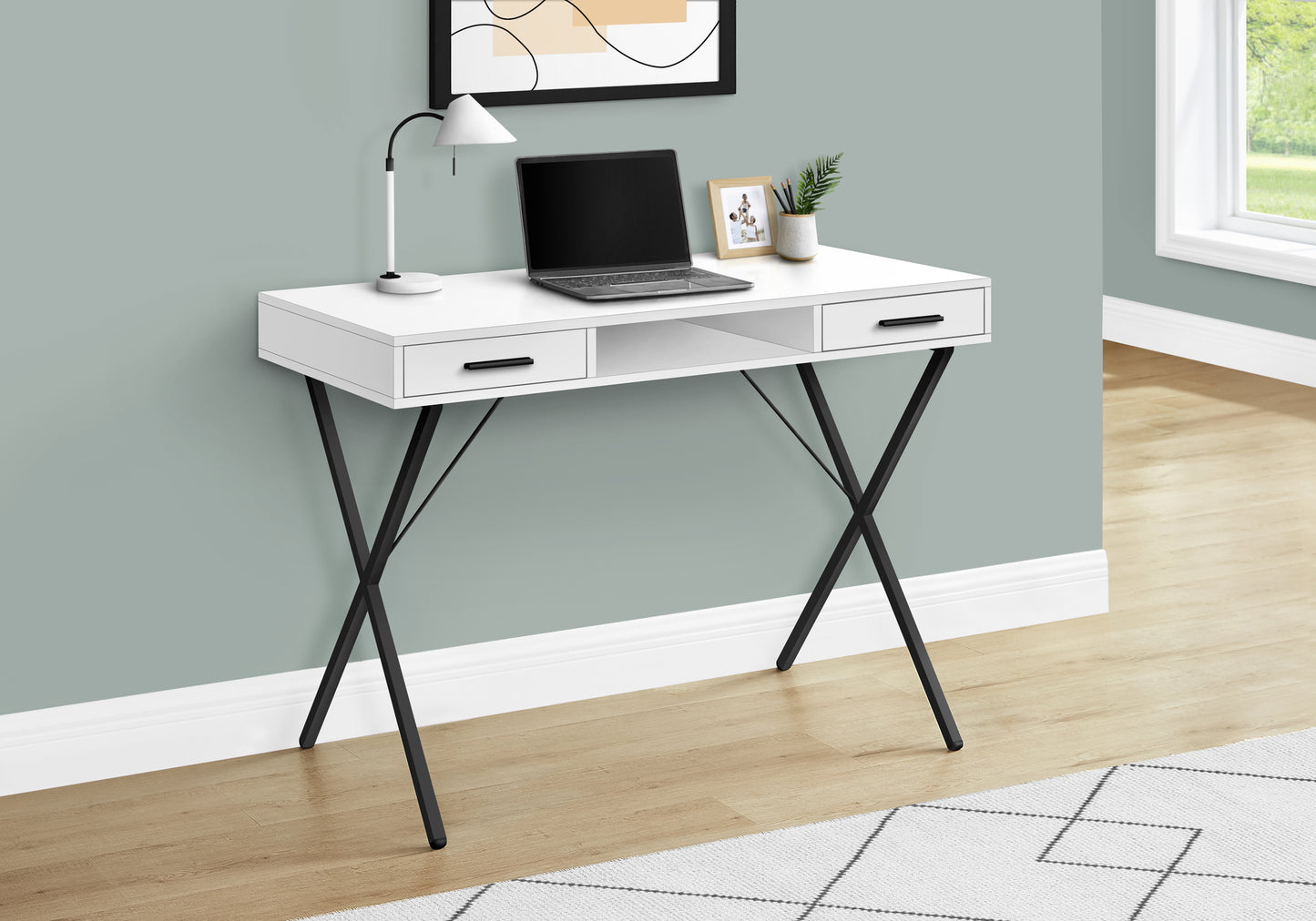 White modern desk with black Xframe legs laptop and desk lamp