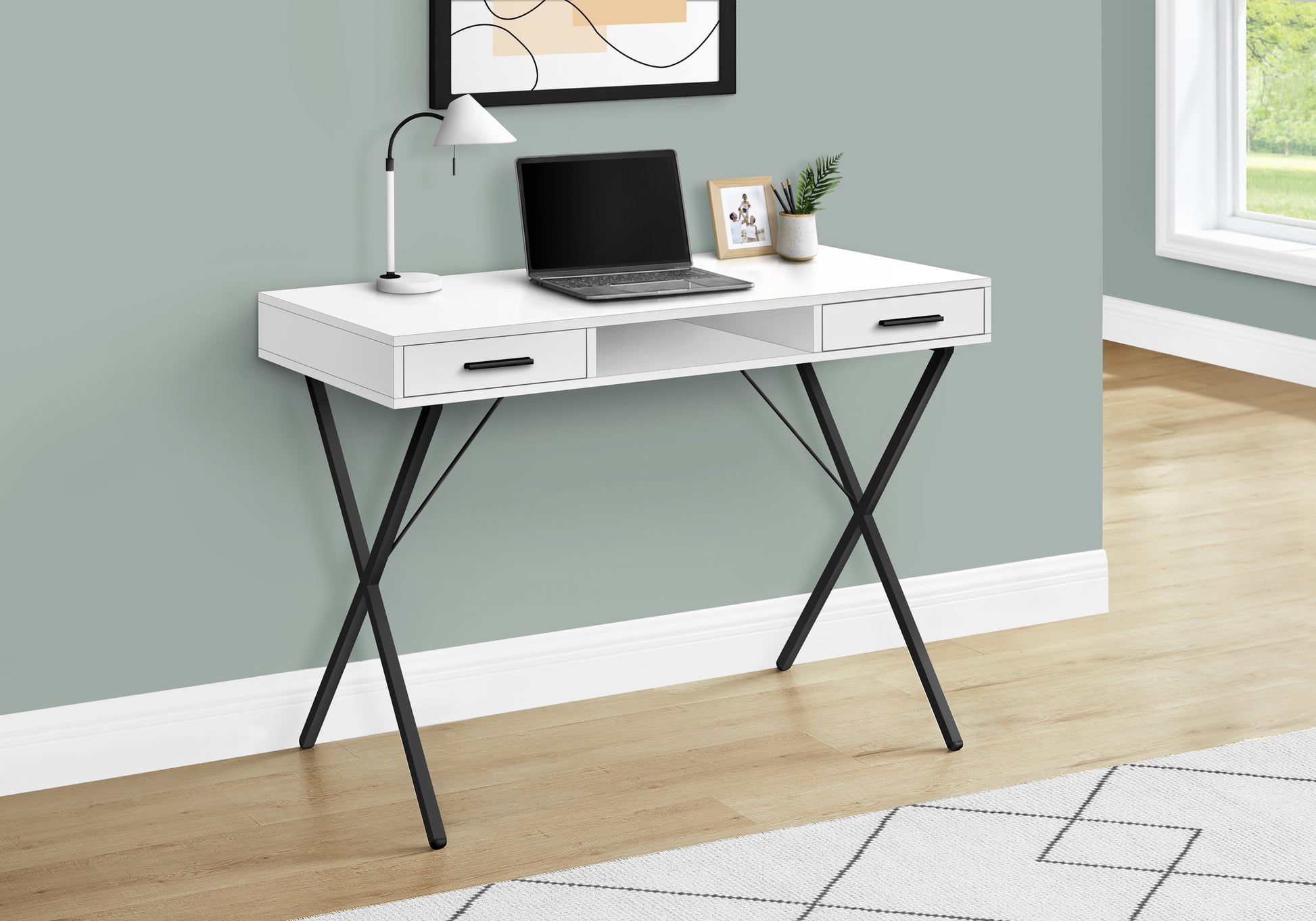 White modern desk with black Xframe legs laptop and desk lamp