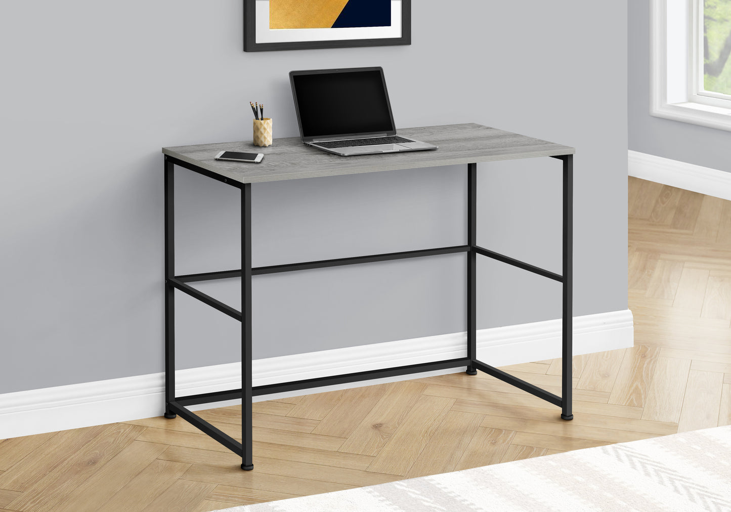 Gray wood grain top standing desk with black metal frame and minimalist design