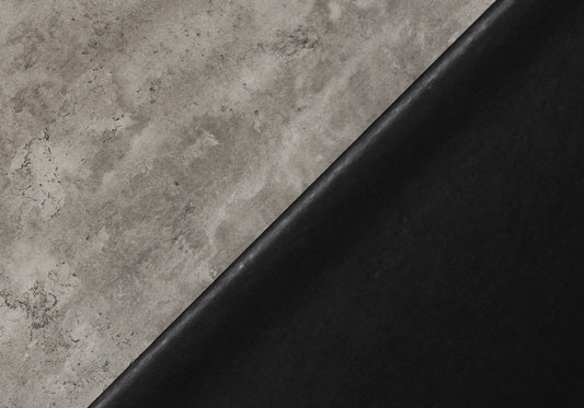Textured grey concrete surface meeting smooth black leather diagonal split