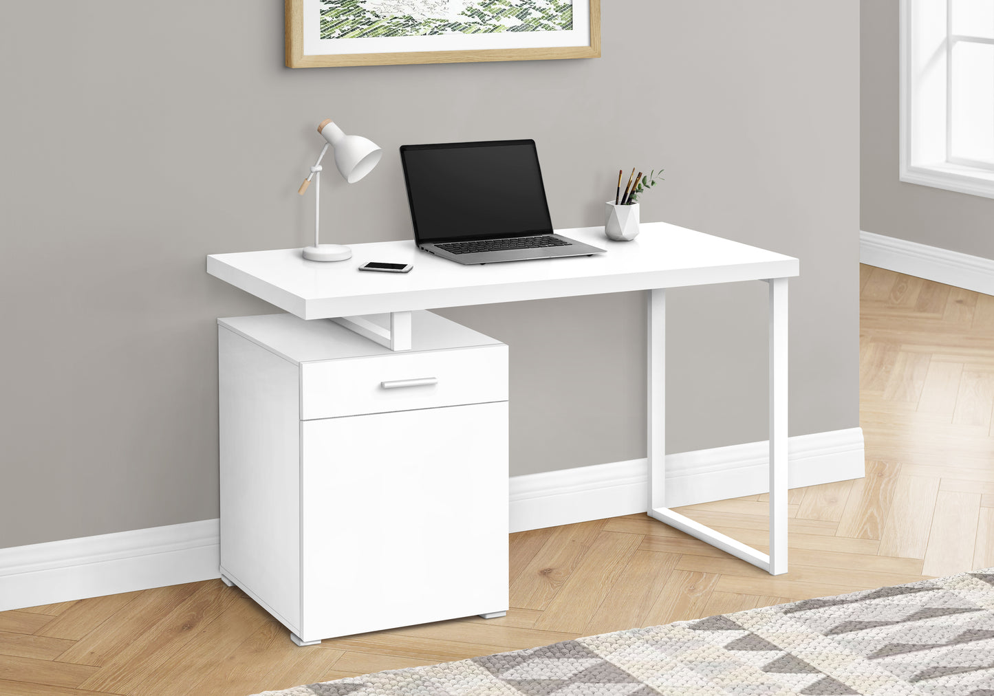 Modern white desk with a drawer unit and integrated laptop perfect for home offices