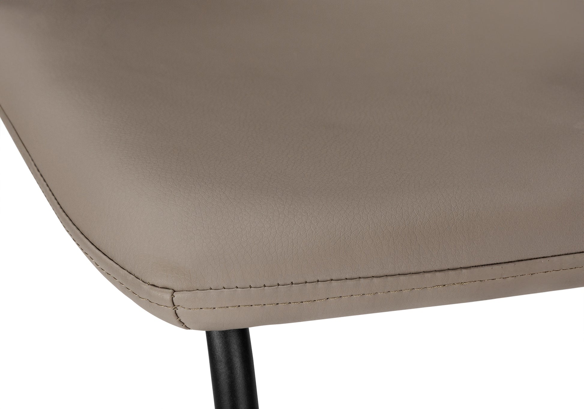 Closeup of a taupe faux leather chair seat with visible stitching detail