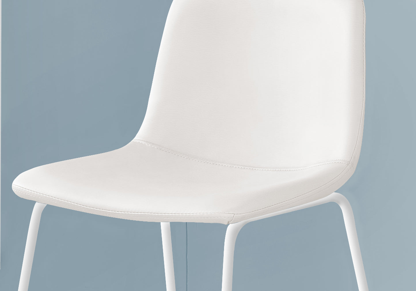 Closeup of a sleek white molded plastic chair with thin metal legs
