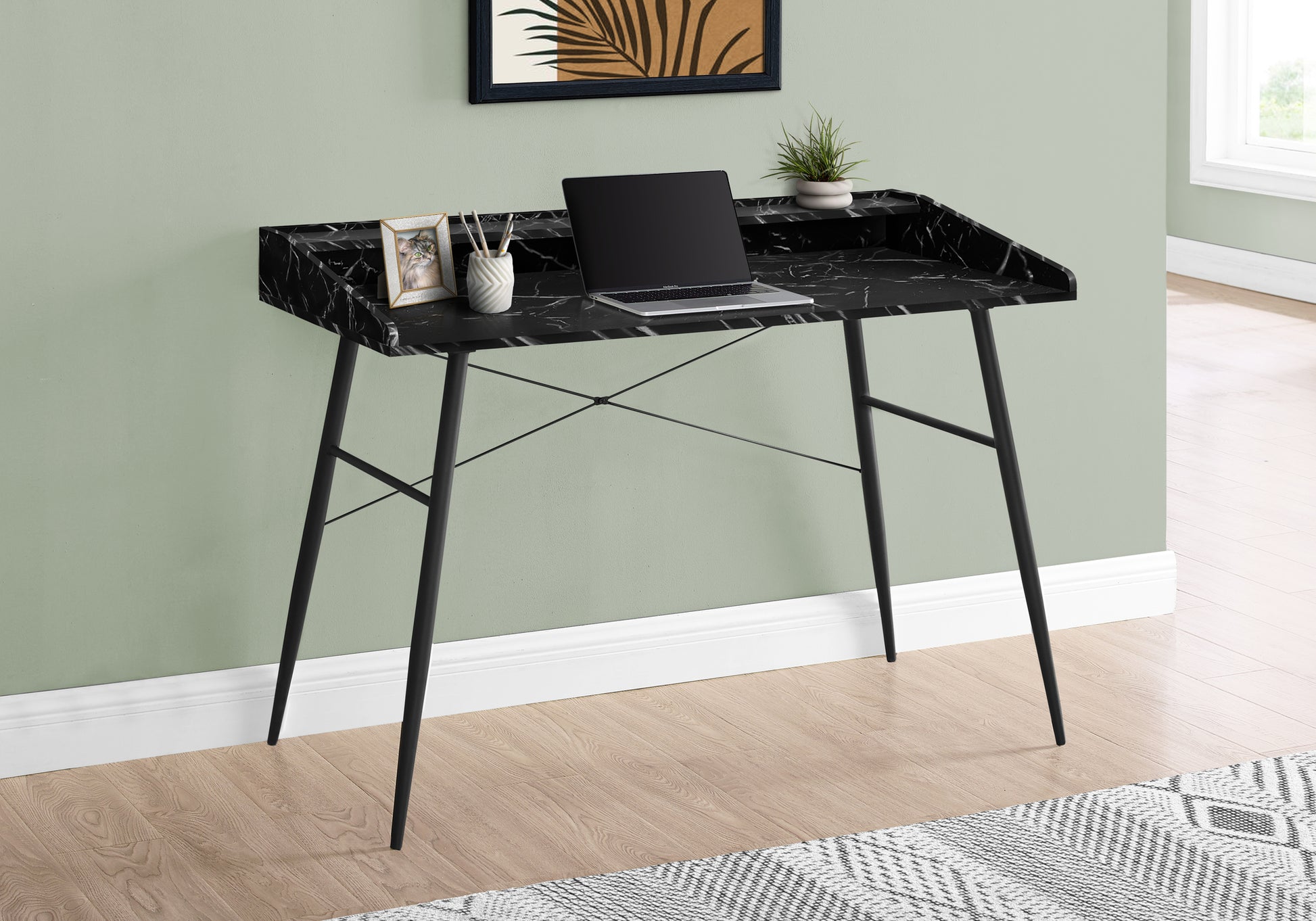 Black marble writing desk with laptop and plant modern home office setup
