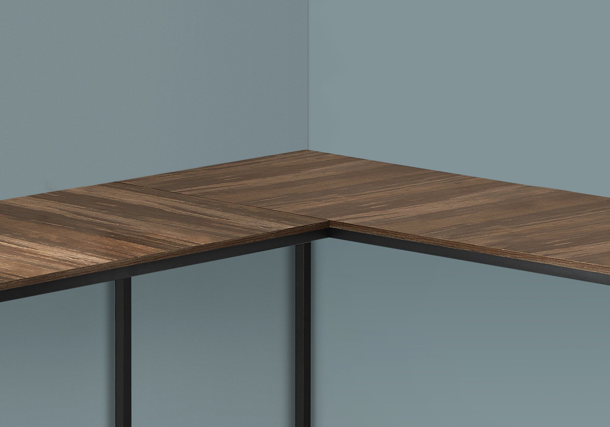 Lshaped desk with rich wood grain veneer and black metal frame