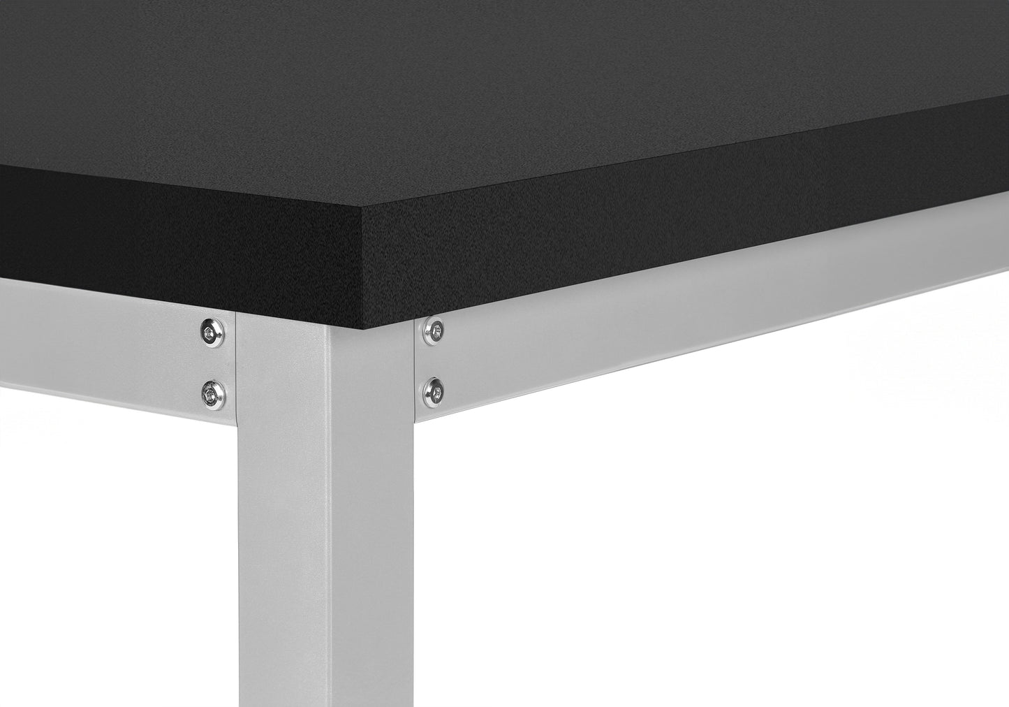 Closeup of a sturdy black workbench top on a silver metal frame