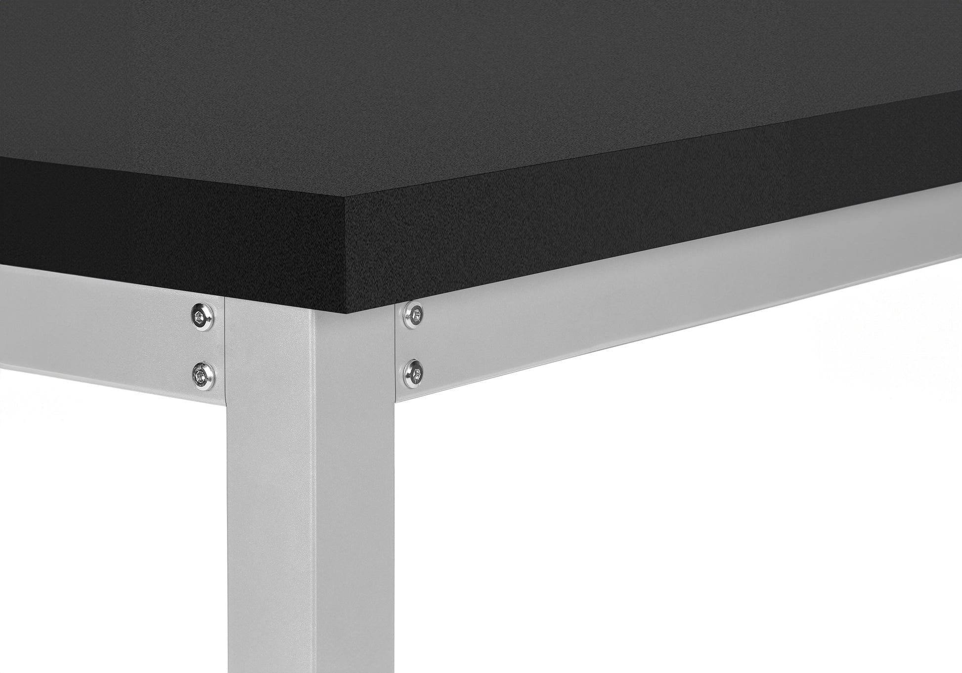 Closeup of a sturdy black workbench top on a silver metal frame