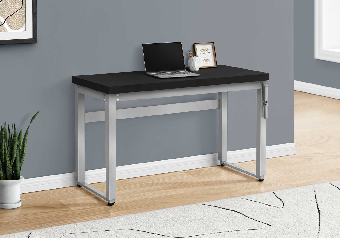 Black top computer desk with silver metal legs laptop and decor present