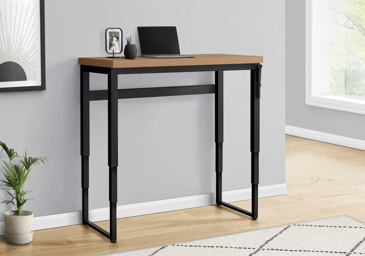 Adjustable height standing desk with natural wood top and black metal frame