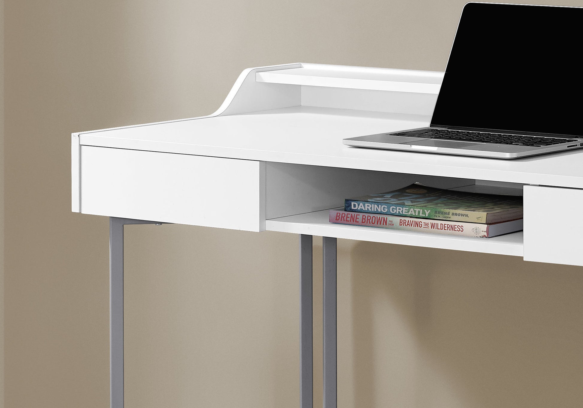 Modern white desk with sleek metal legs and a laptop