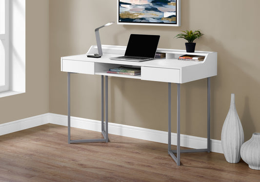 Modern white writing desk with silver legs featuring a laptop and decorative items
