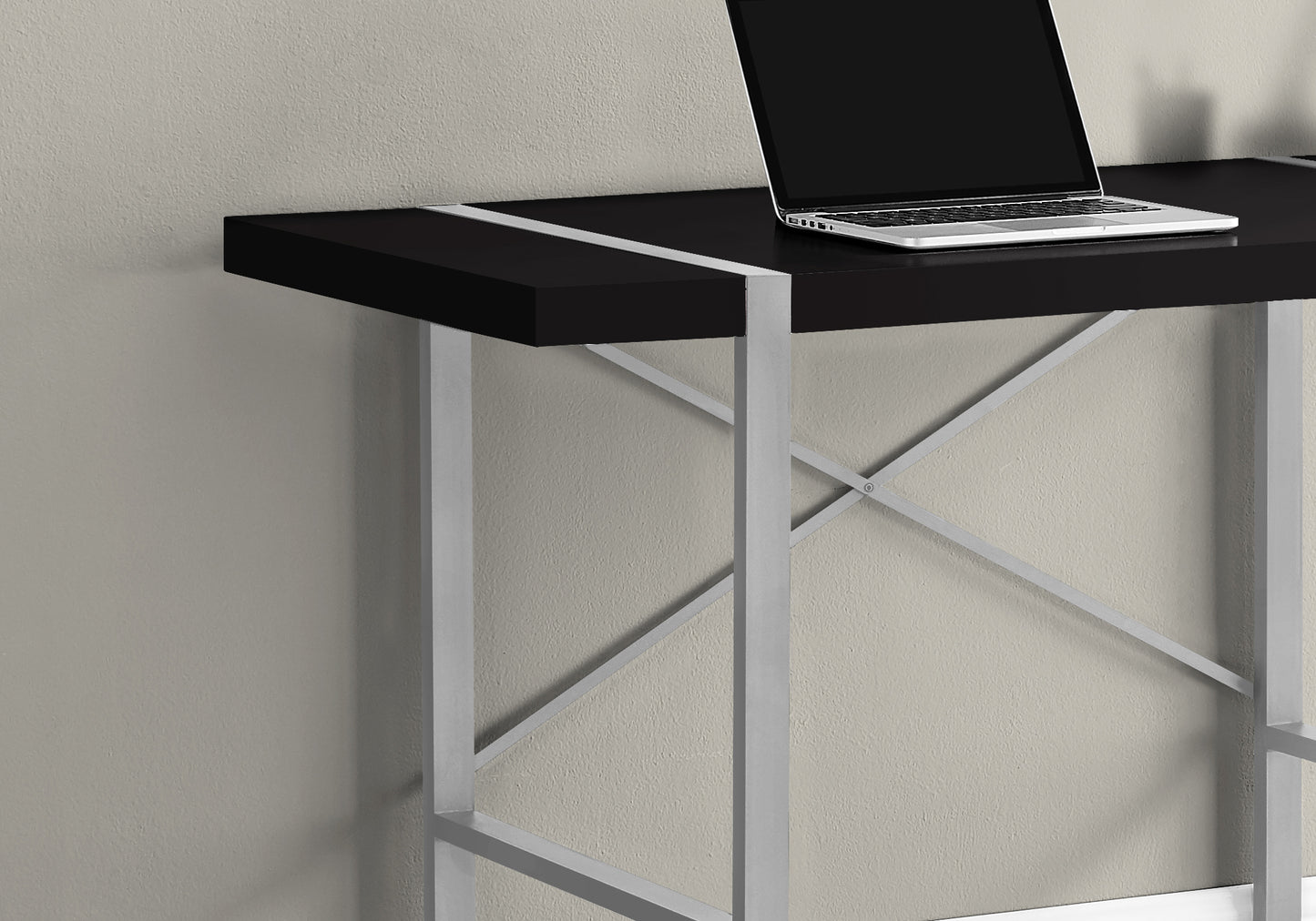 Sleek black desk with silver accents and metal Xframe legs ideal for a modern home office setup