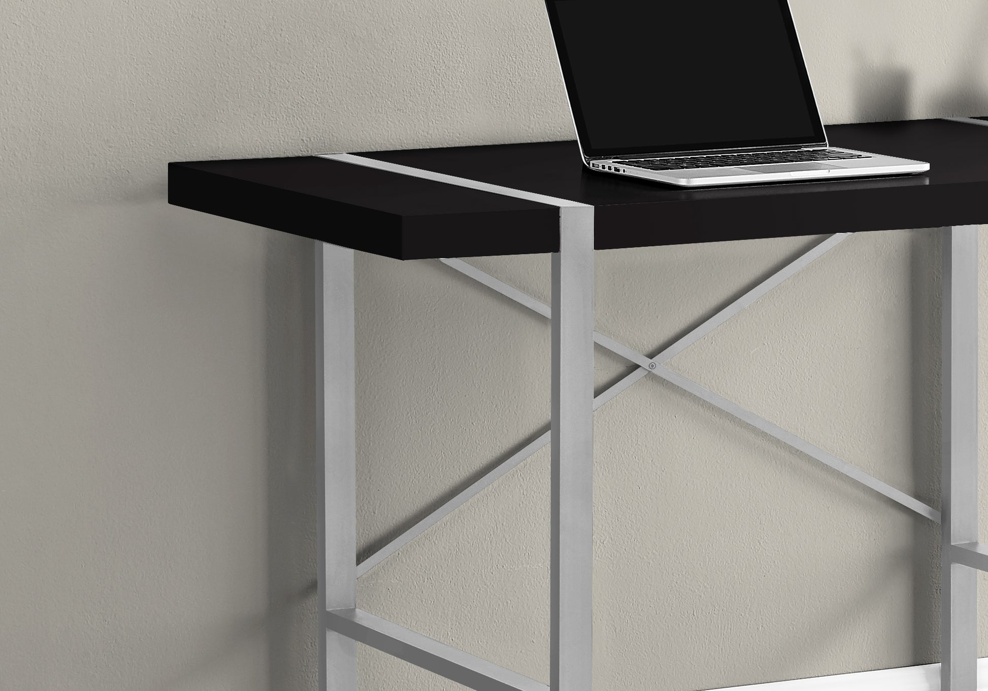 Sleek black desk with silver accents and metal Xframe legs ideal for a modern home office setup