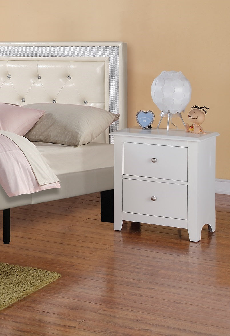 White twodrawer nightstand with silver knobs and decorative lamp