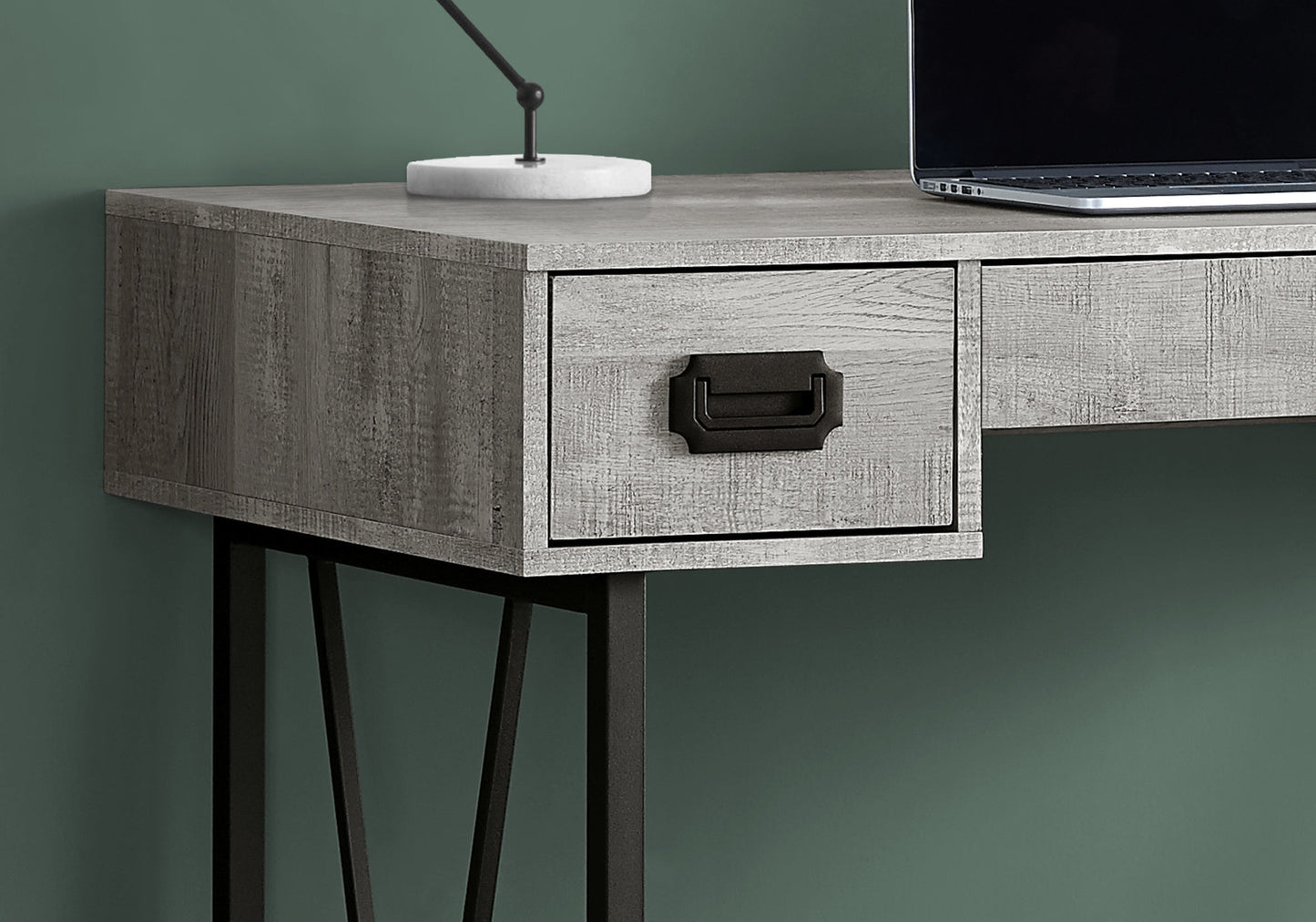 Rustic gray wood desk with a black industrialstyle drawer pull and metal legs
