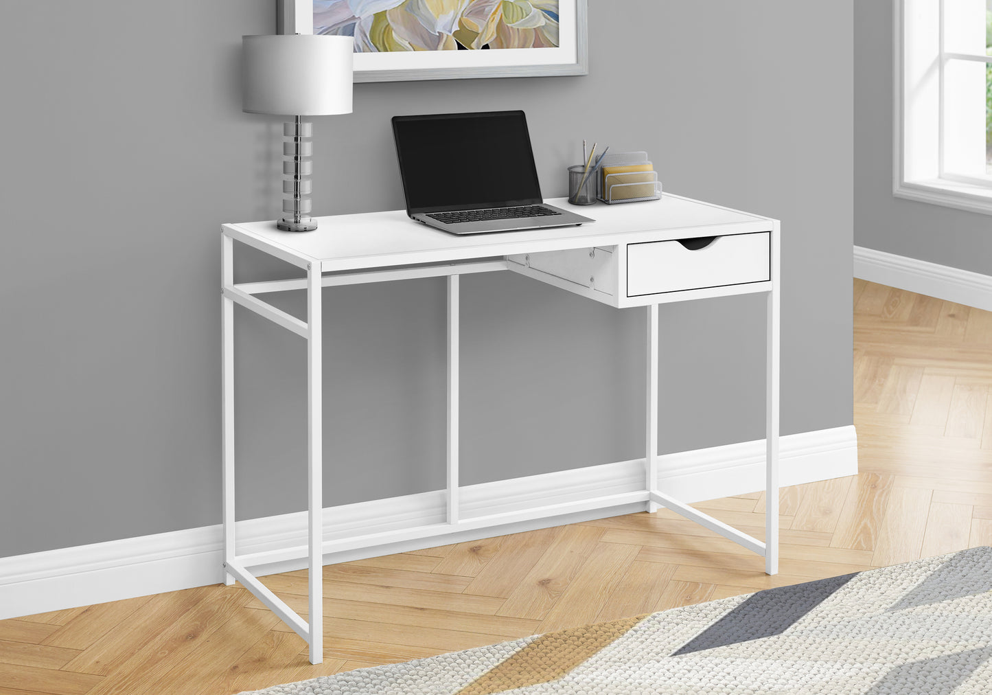 White metal desk with single drawer and laptop perfect for small home office