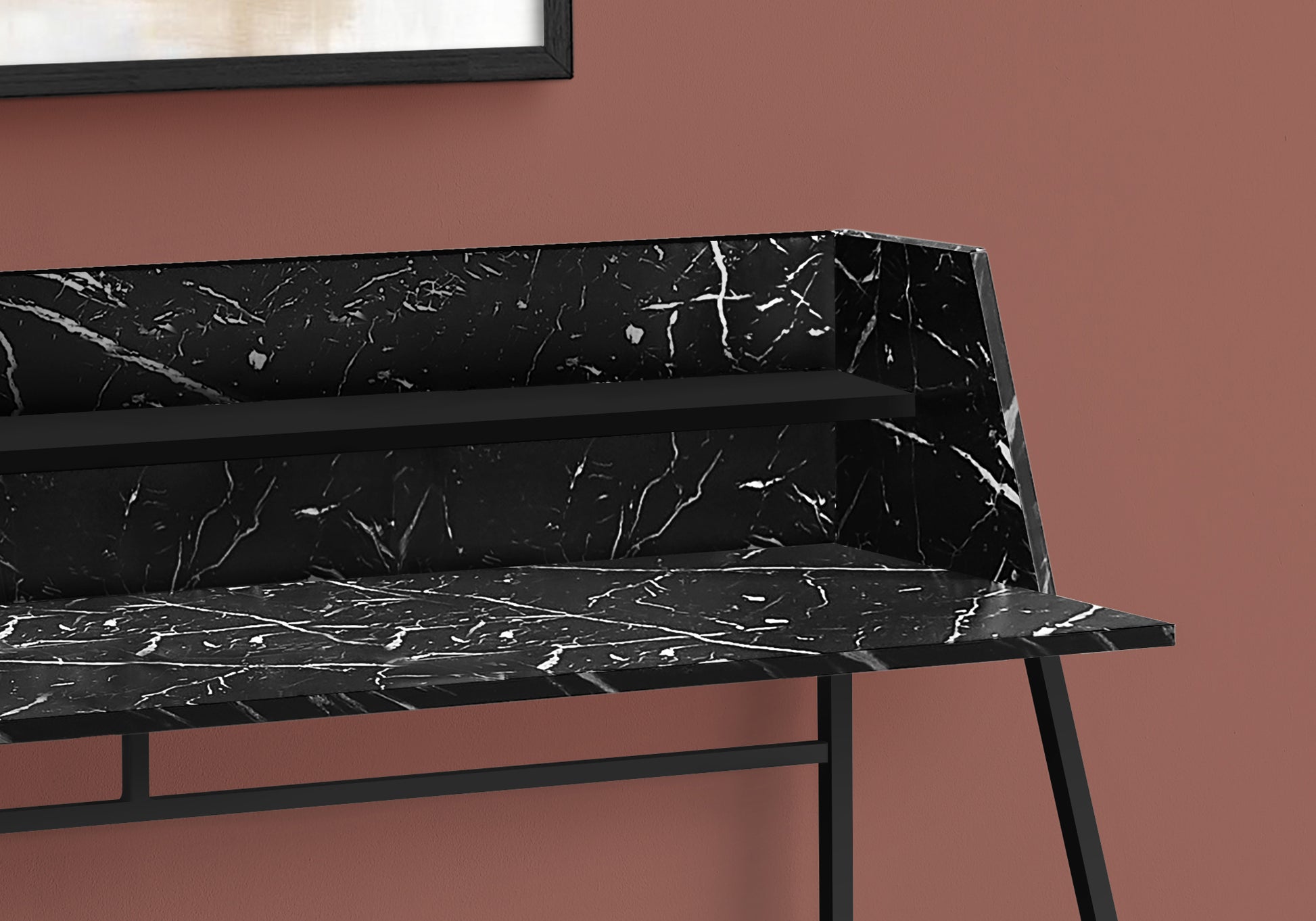 Black marble writing desk with white veining and a sleek metal frame