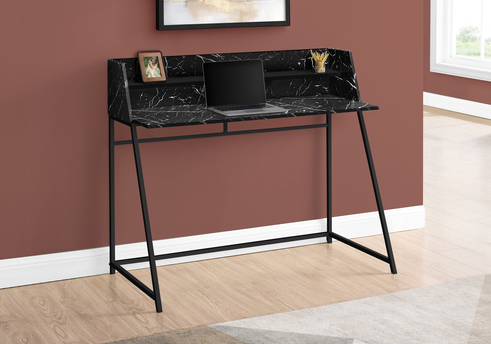 Modern black marble writing desk with a laptop and framed photo for elegant home office