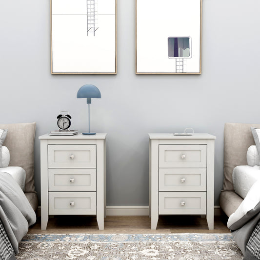 White threedrawer bedside table with silver knobs