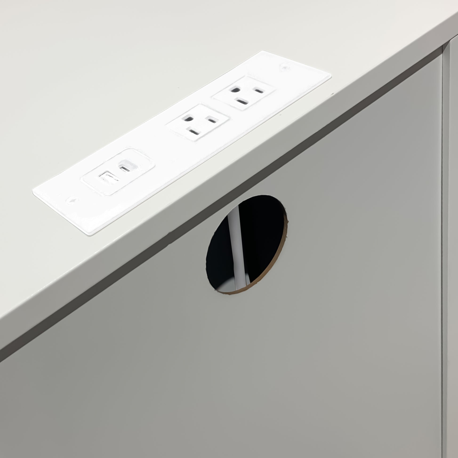 White recessed desk grommet with two AC outlets and USB port