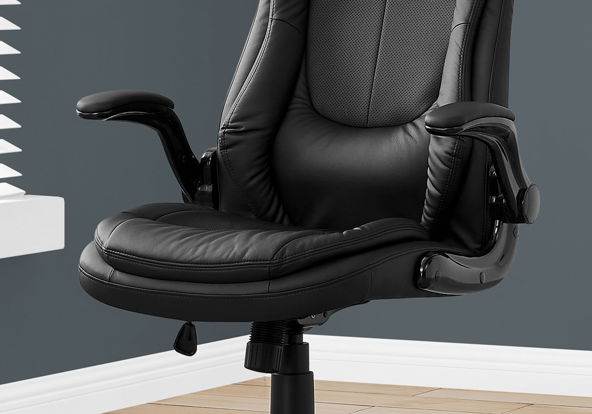 Black leather executive office chair with padded armrests and adjustable height