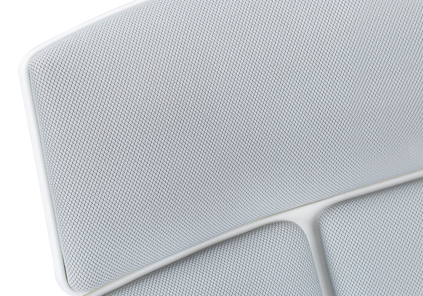 Closeup of white mesh fabric with hexagonal pattern on modern chair seat