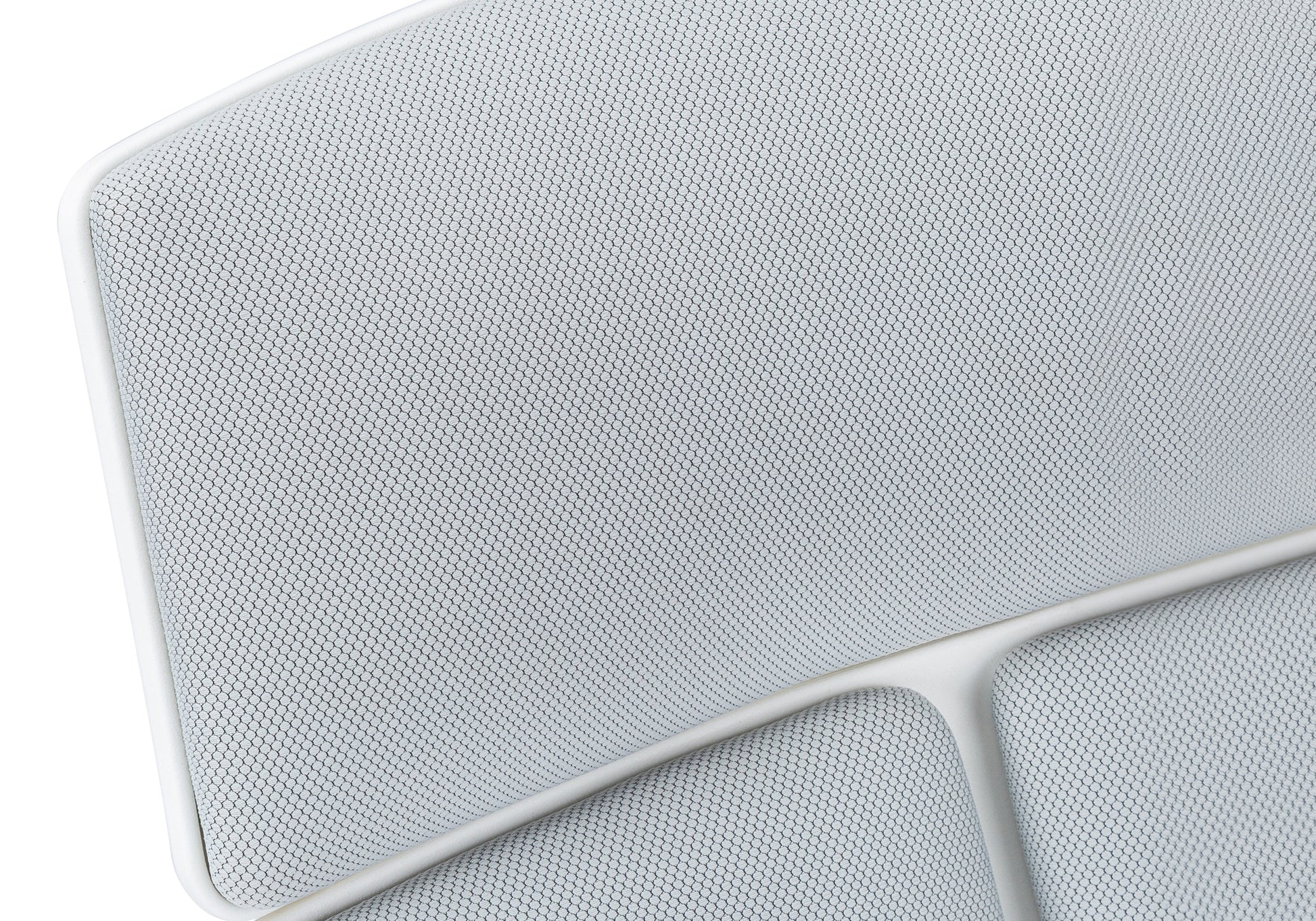 Closeup of white mesh fabric with hexagonal pattern on modern chair seat