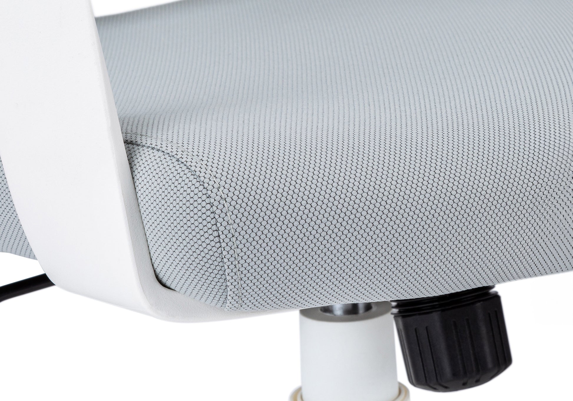 Closeup of a light grey mesh fabric on an ergonomic office chair seat