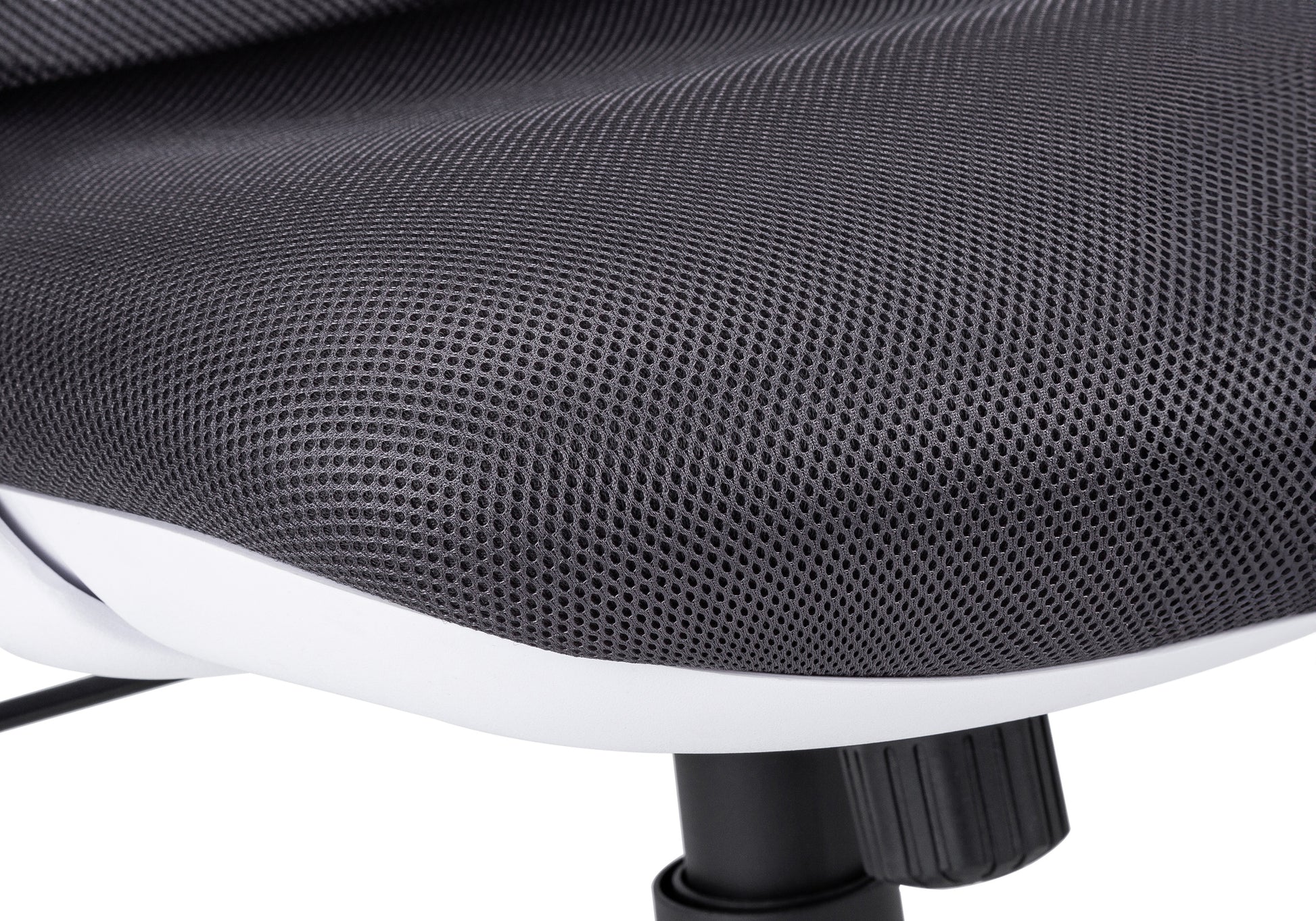 Closeup of dark grey mesh fabric on an ergonomic office chair seat