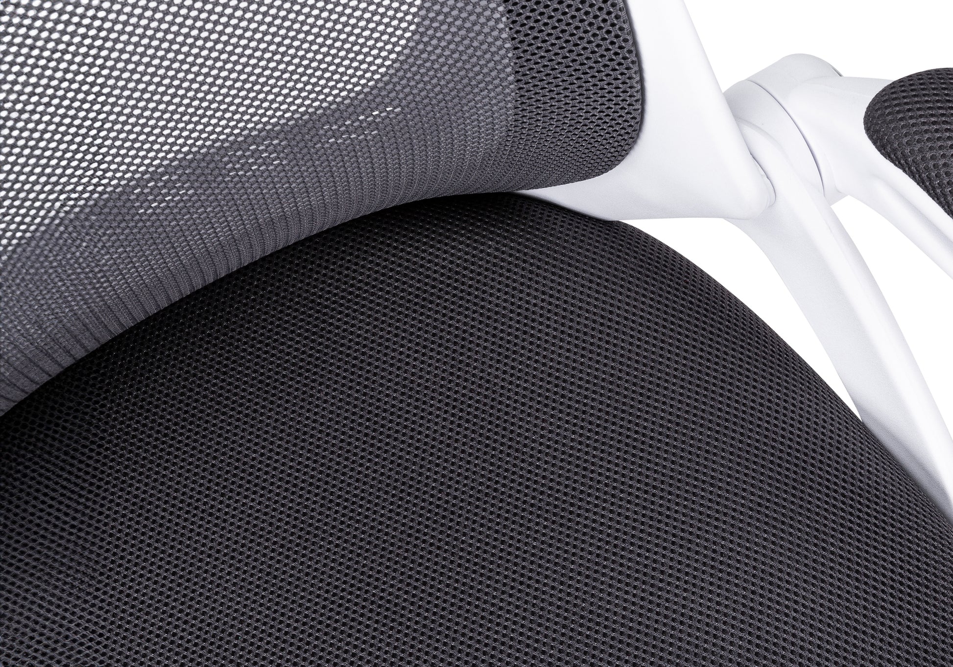 Closeup of black mesh fabric on a modern ergonomic office chair seat