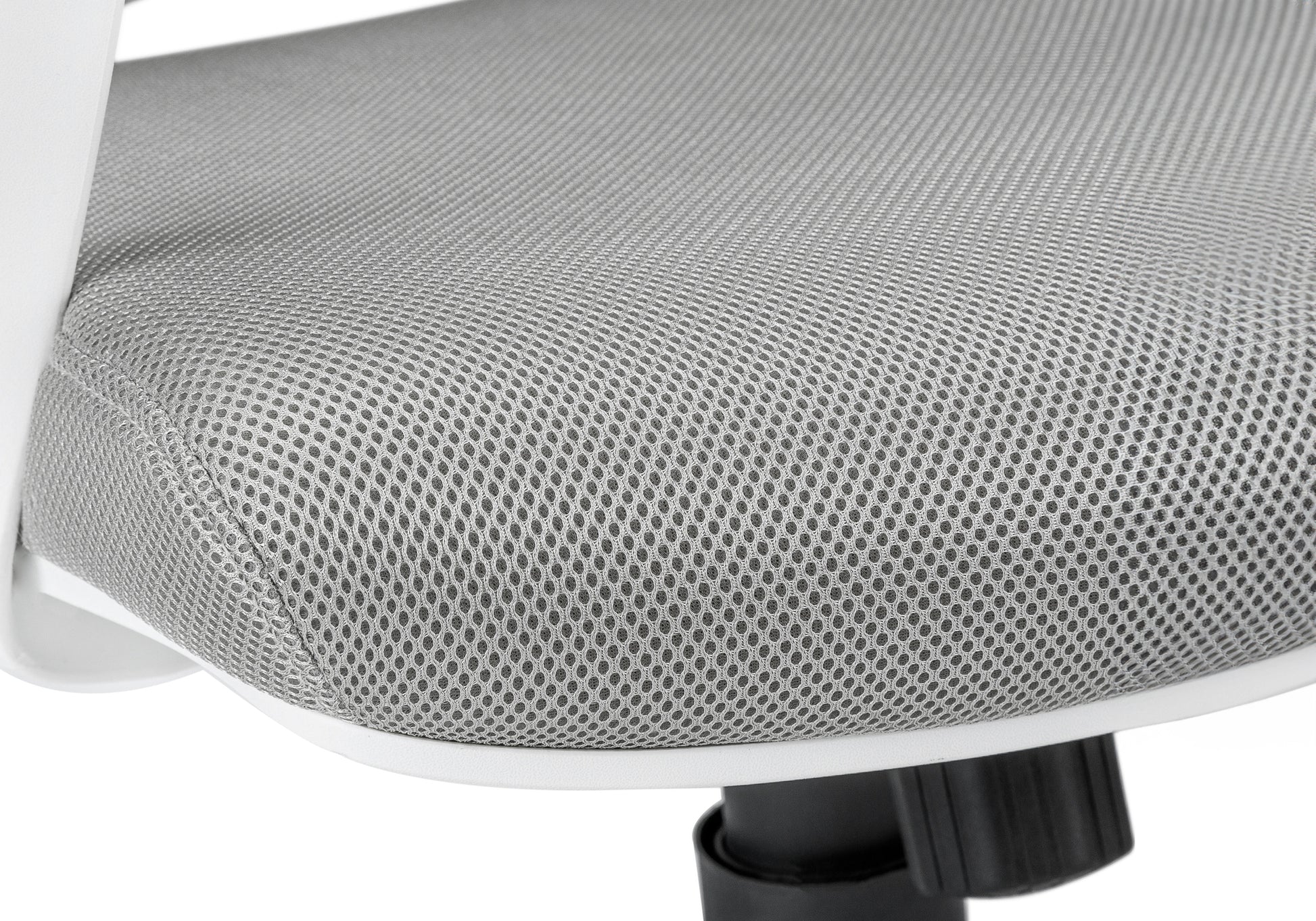 Closeup of a grey mesh office chair seat with white trim and a black base