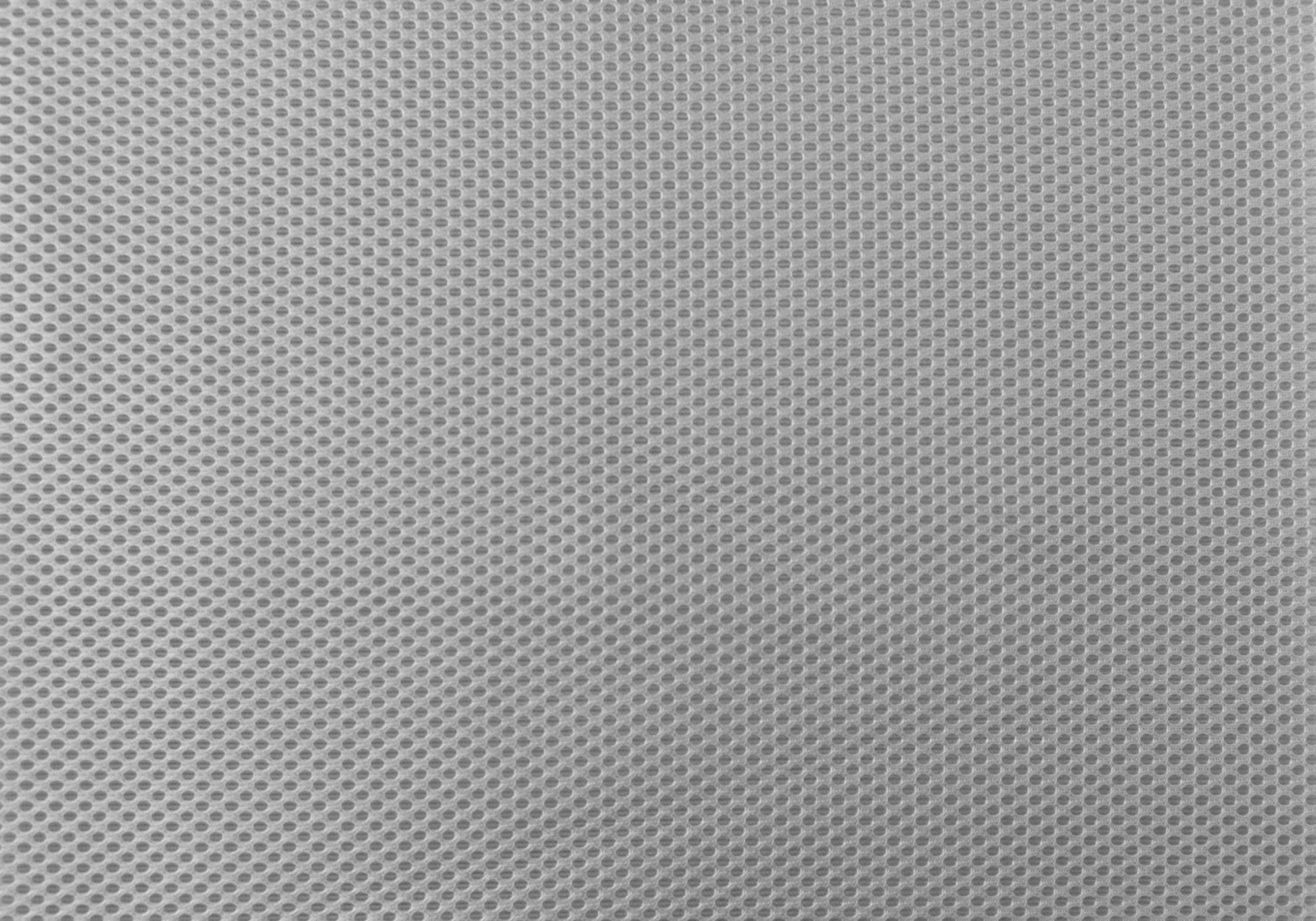 Closeup of light gray mesh fabric with small uniform circular perforations ideal for breathable upholstery
