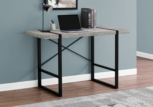 Gray wood grain desk with black metal legs featuring a laptop and lamp for a modern home office setup