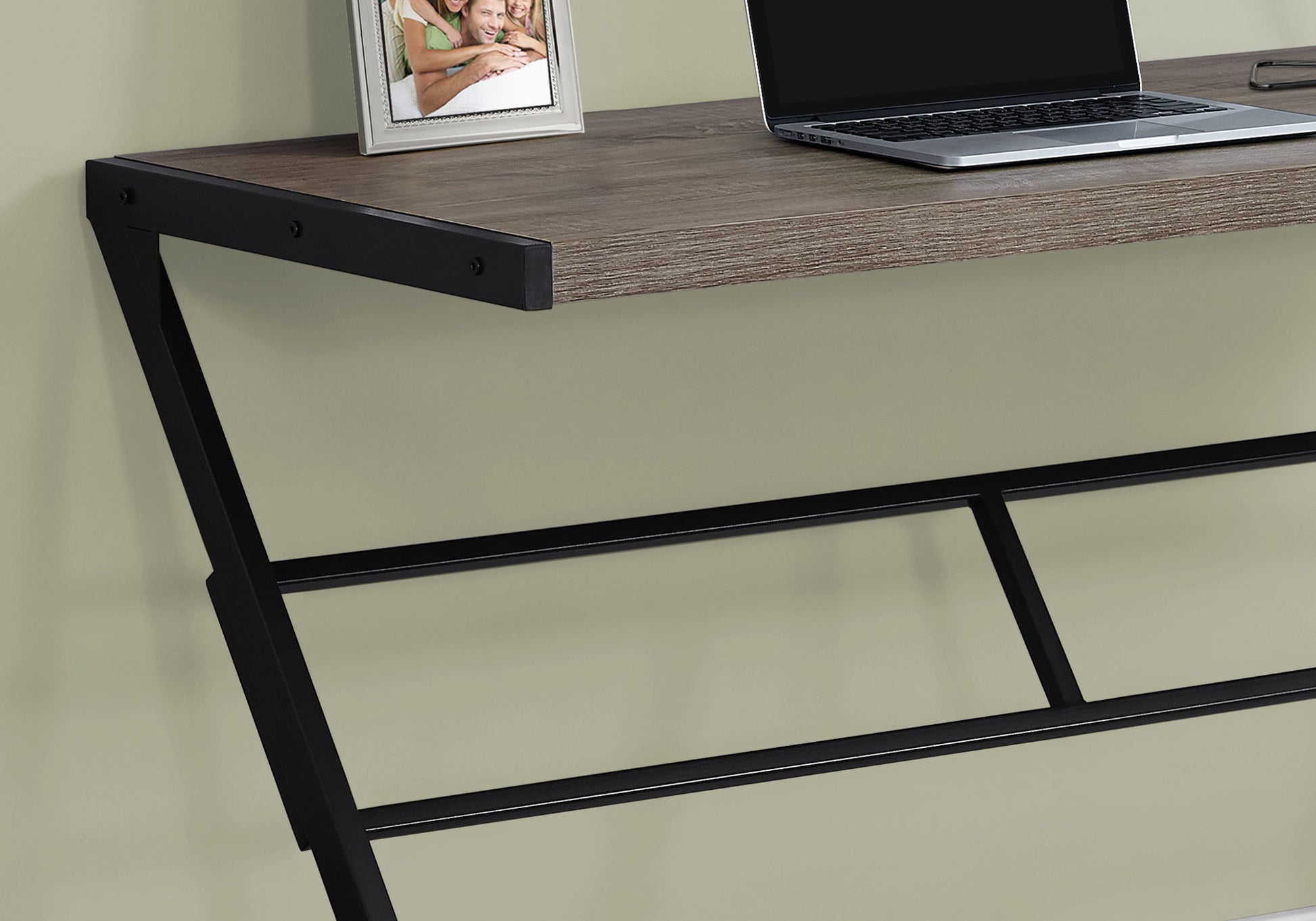 Rustic wood grain desk with black metal frame and laptop