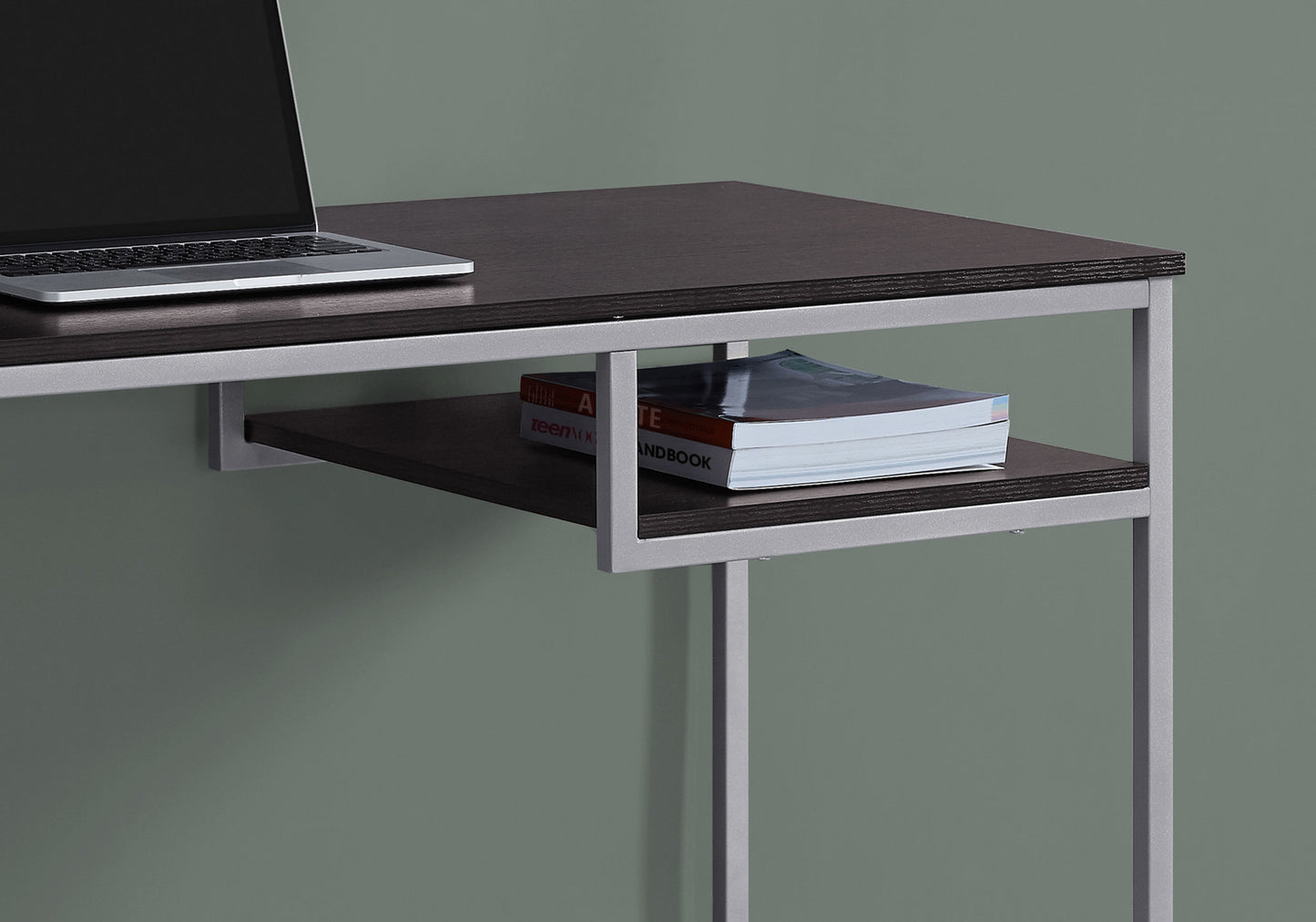 Modern dark wood desk with silver frame and open shelf holding two books