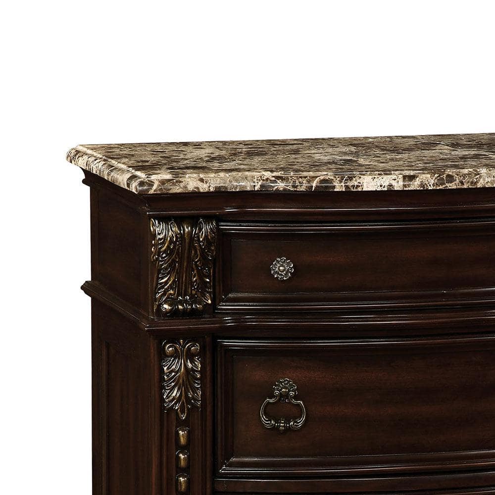 Dark wood dresser with carved details and marble top
