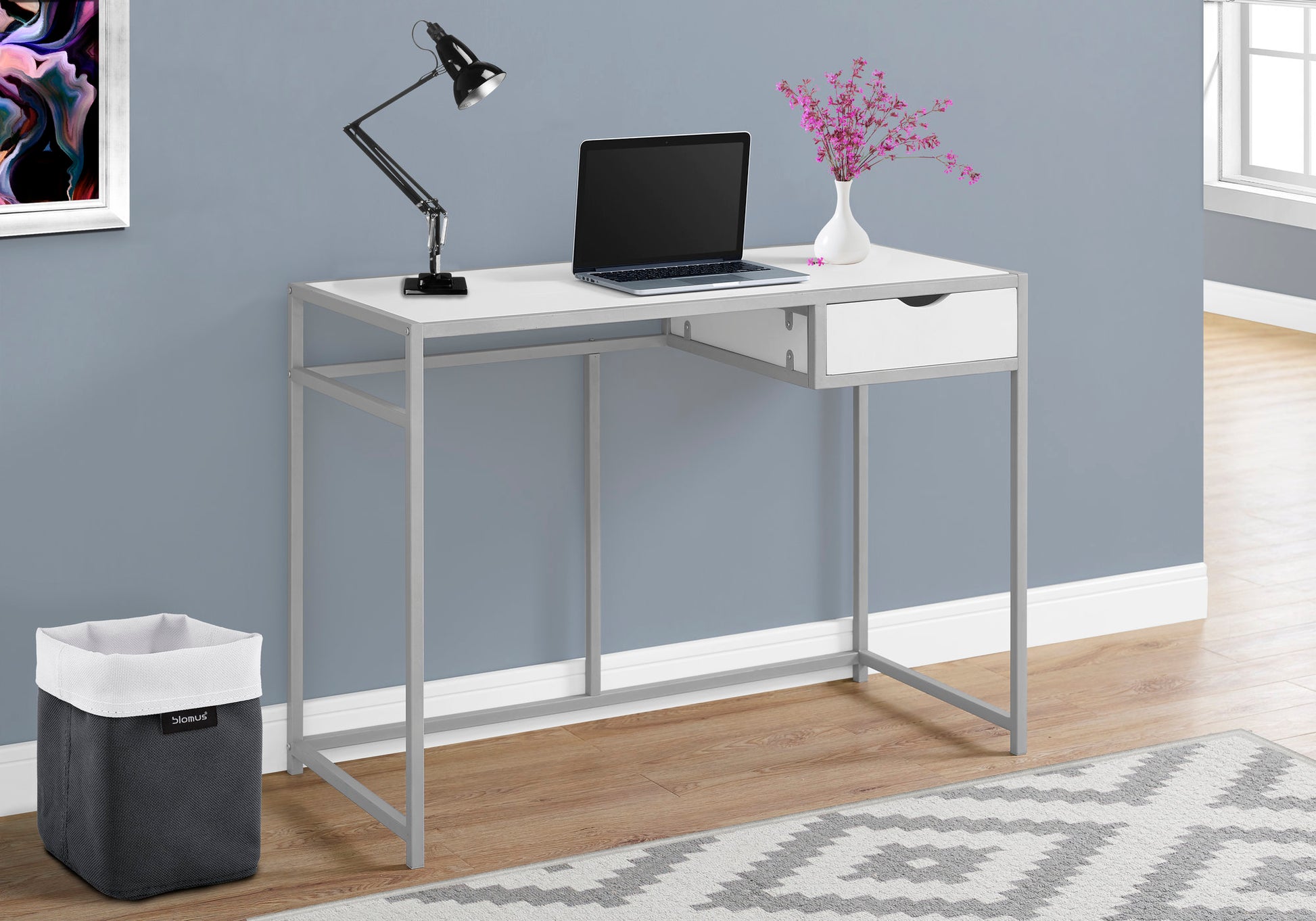 White and silver metal desk with a drawer laptop and black task lamp