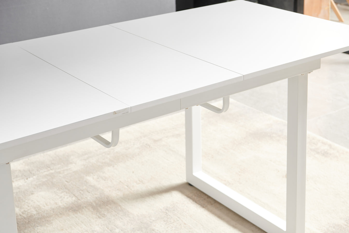 Modern white dining table with extending leaf mechanism for flexible seating