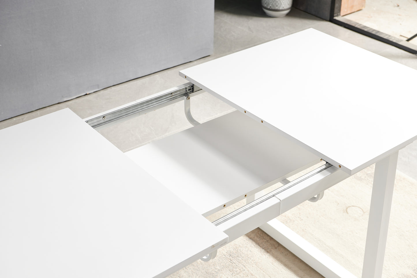 White extendable dining table with metal sliding mechanism