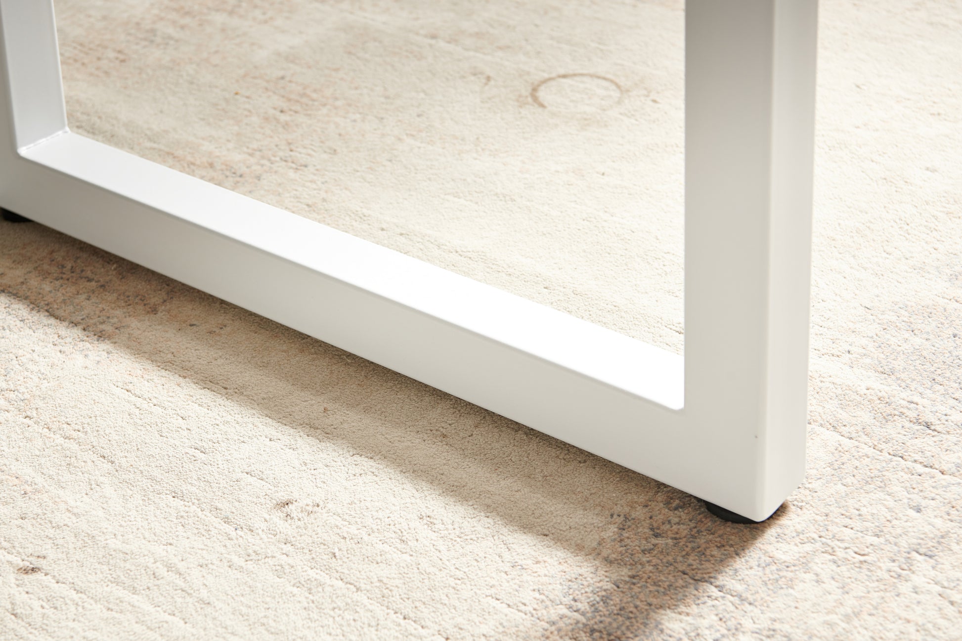 White metal table leg with clean lines showcasing modern furniture design
