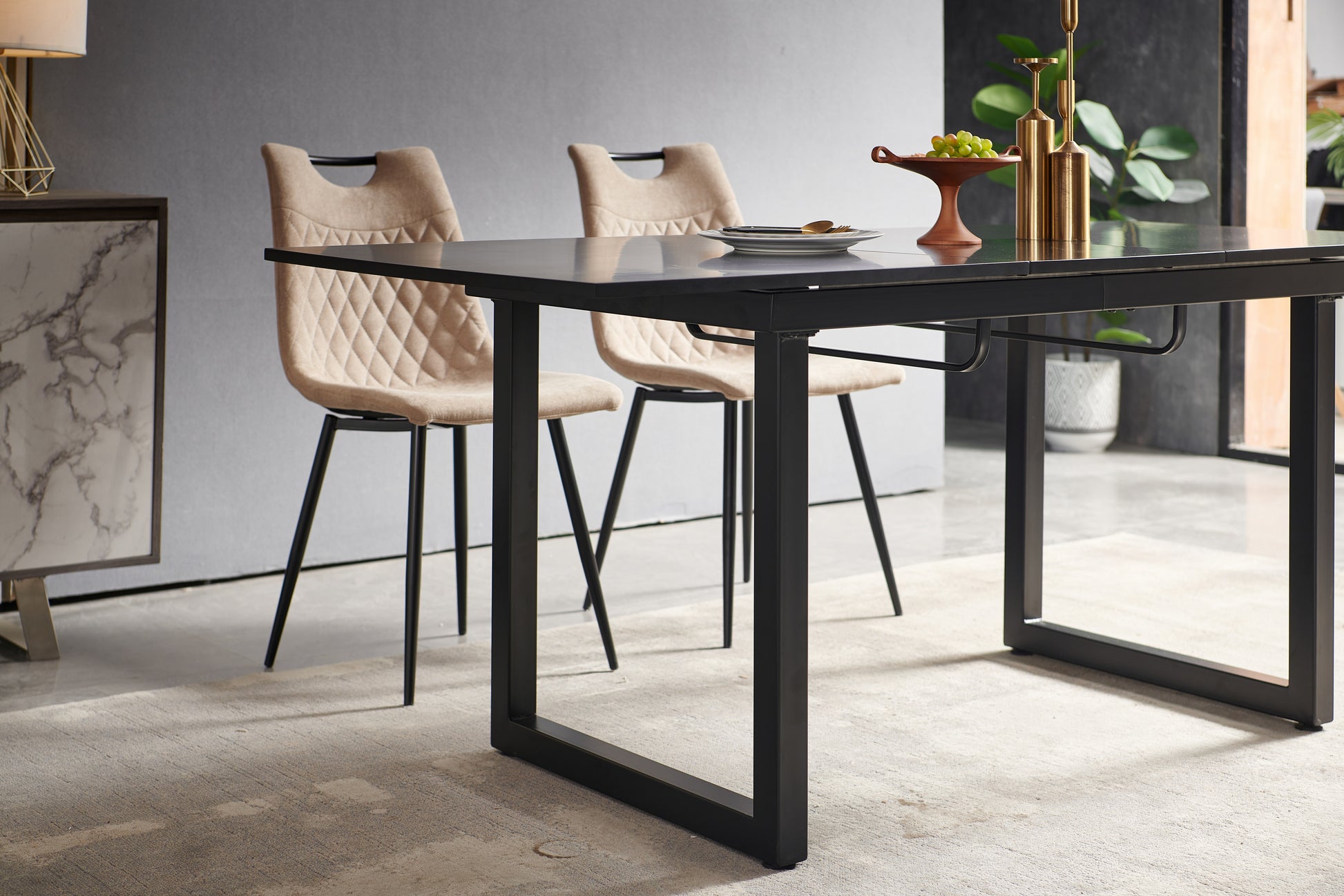 Modern black dining table with two upholstered beige chairs diamond tufted back