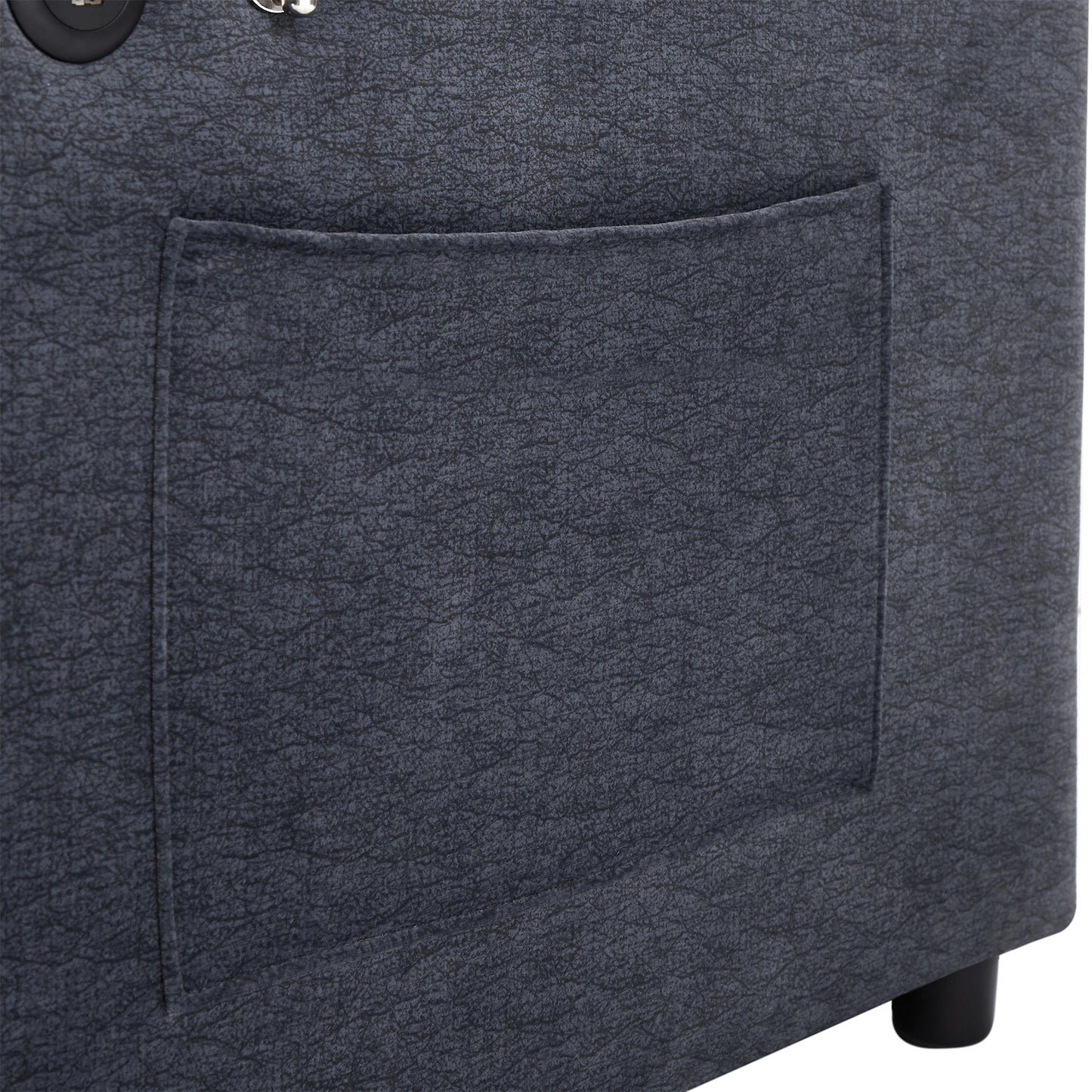 Closeup of dark grey faux leather storage ottoman with stitched pocket detail