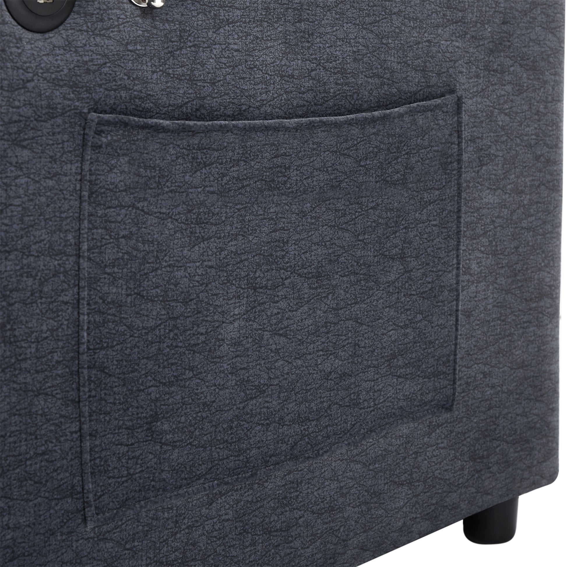 Closeup of dark grey faux leather storage ottoman with stitched pocket detail